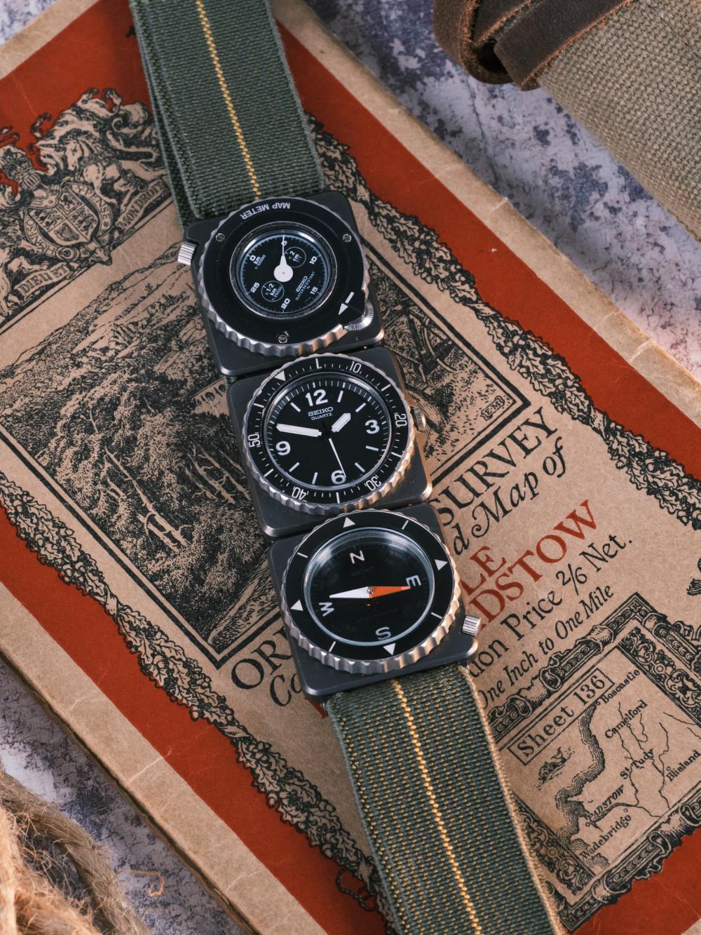 Seiko Fieldmaster Contra modular watch laid flat on a vintage Ordnance Survey map, showing the stacked time, map meter, and compass modules on a green fabric strap, styled with field gear accents.