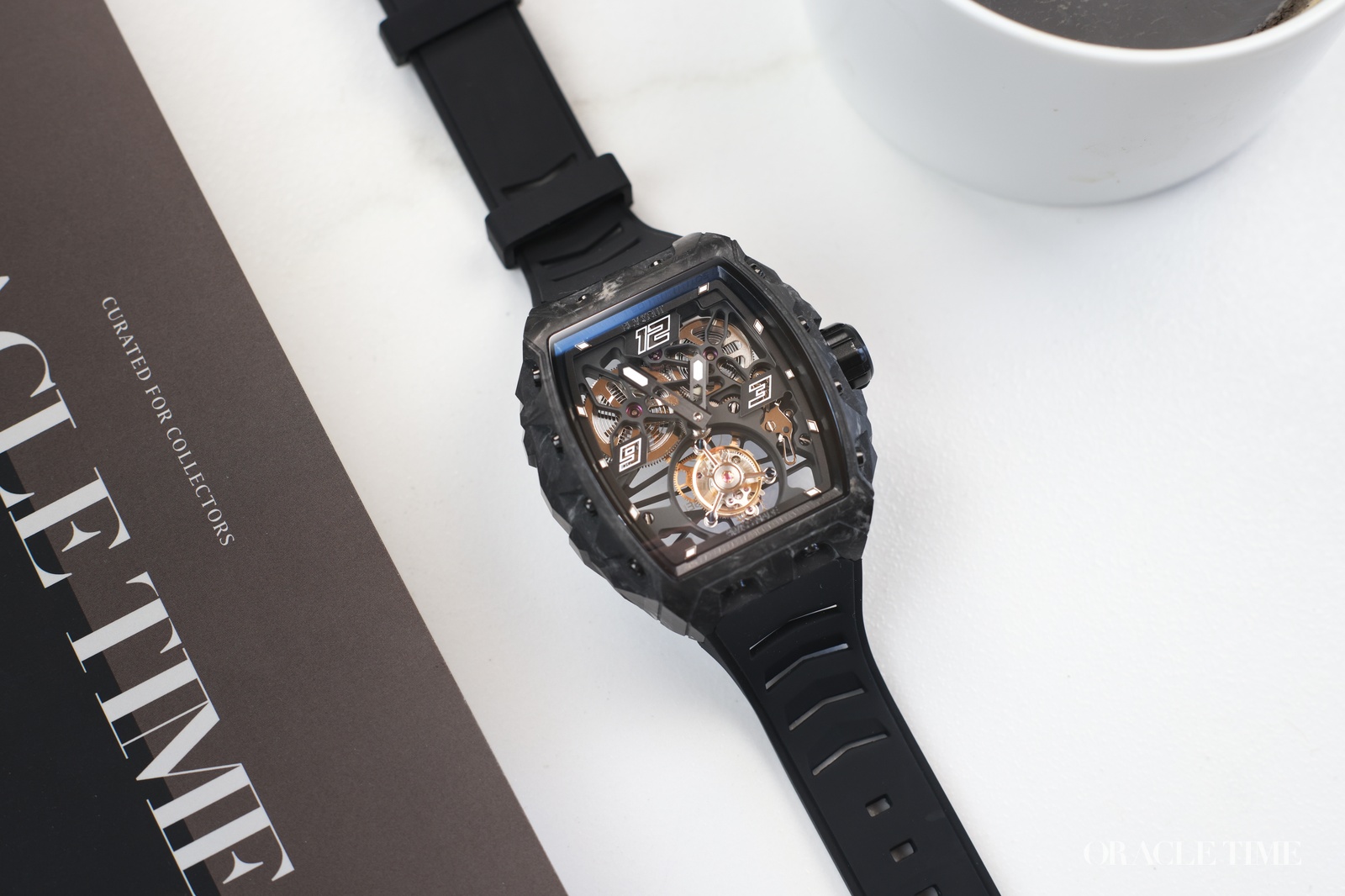 One of the trends we anticipated at the start of the year is the continuing growth in accessible haute horology. New technology and manufacturing techniques mean that materials and complications once reserved for the most exclusive ateliers are now available to a new wave of independent brands. One such brand at the forefront of this wave is Blackout, who have created the XP1 Tourbillon Swiss Made at a price less than five figures. I’ve been hands-on to learn more.
The inclusion of Swiss Made in the name of this watch is an important distinction because historically Blackout has used Swiss expertise and Asian components, which while perfectly acceptable often carries a certain stigma. This time though, they have adhered to the requirements of the Swiss Made designation, meaning the watch has a movement assembled by a Swiss manufacture, a minimum of 60% of the production is carried out in Switzerland, the watch is assembled in Switzerland and quality control is conducted in Switzerland.
Aesthetically, the XP1 Tourbillon Swiss Made falls into the category of urban sports watches with a bold integrated bracelet and high-performance materials. Specifically, it has a tonneau case measuring 44mm x 52mm with a thickness of 14.8mm made from Blackout’s UAC forged carbon. On the wrist that makes it quite a beast in terms of size, sitting tall and proud. Though the sharp downward angle of the integrated rubber strap means it sits on my wrist surprisingly well. The spring leaf deployant clasp is also easy to use and comfortable.
Forged carbon is a robust, lightweight material made from chopped carbon fibres that are pressed together under extreme pressure and heat with a resin to create a composite material with a distinct surface pattern unique to each watch. Blackout’s specialty is adding luminous powders to the resin so that it glows under UV light adding an extra visual element to the design. The structure of the case is very robust with chunky shapes and visible screws along the flanks.
For the dial, the XP1 Tourbillon Swiss Made presents a skeletonised display with black architecture suspending the movement’s core components. The tourbillon performs its ballet at 6 o’clock, with the balance spring oscillating back and forth inside its rotating cage. The other prominent features are the twin power barrels at 2 o’clock and 10 respectively. It’s fun to see the springs getting wound tauter and tauter as you wind the crown.
The movement itself is the DW&Co Swiss Made flying tourbillon, D.W & Co. being a watchmaking workshop and service centre in Geneva with both COSC chronometer and Poinçon de Genève calibres to their name. The movement here has an 80-hour power reserve with chronometer level accuracy of -0/+6 seconds per day.
Blackout Watches XP1 Tourbillon