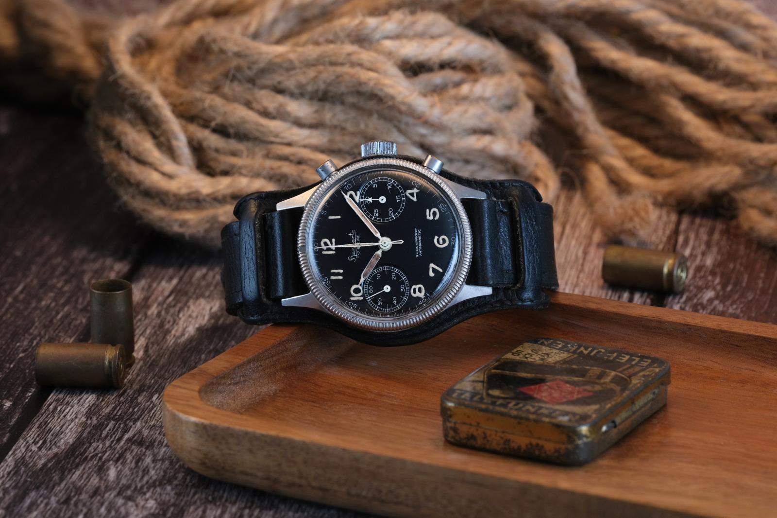 This late-1950s Hanhart 417 ES is thought to be one of around 500 stainless steel examples produced. Sold to the civilian market rather than issued to the German Air Force, it remains complete with its original Bund strap, paperwork and 1961 sales receipt, offering a remarkable snapshot of Hanhart's post-war history.